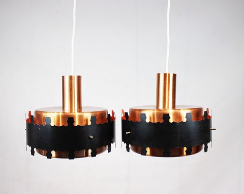 A pair of pendants in copper and black metal of danish design from the 1970s.
